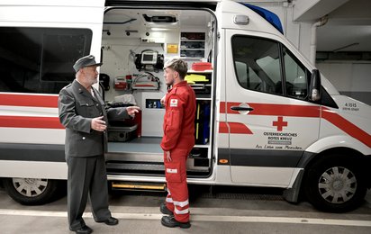 Franz Neuhauser (l.) und Bernhard Lehner (r.) stehen vor dem Rettungsauto in der Dienststelle Steyr.